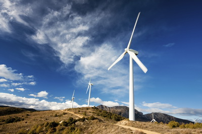 Wind turbines use large blades to catch the wind and turn the rotor 